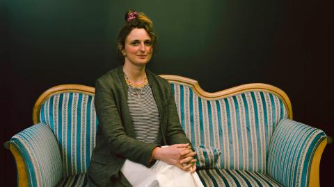 Filmemacherin Alice Rohrwacher sitzt auf einem antiken Sofa