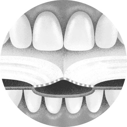 Fotomontage: ein Gebiss hält ein Buch zwischen den Zähnen